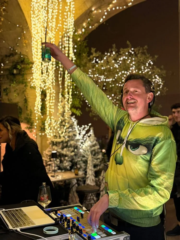DJ Nick raising a cocktail