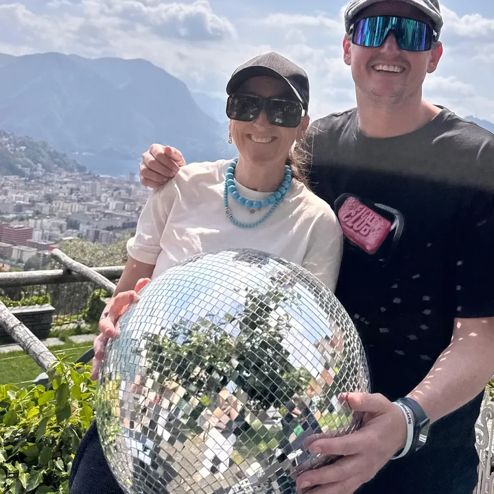 Couple with a disco ball above Lugano